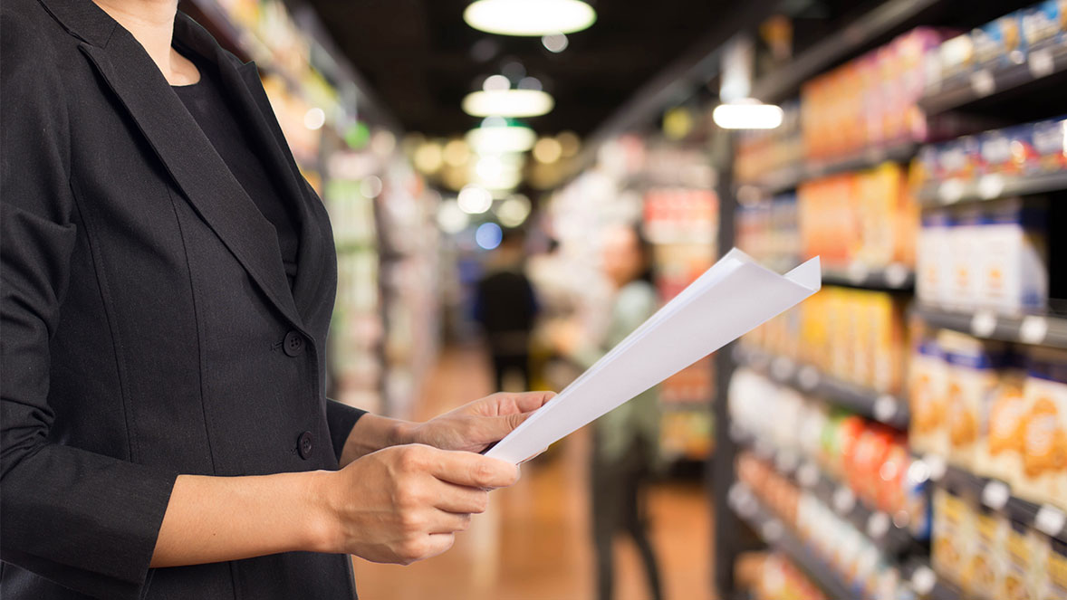 Lady in retail store holding paper